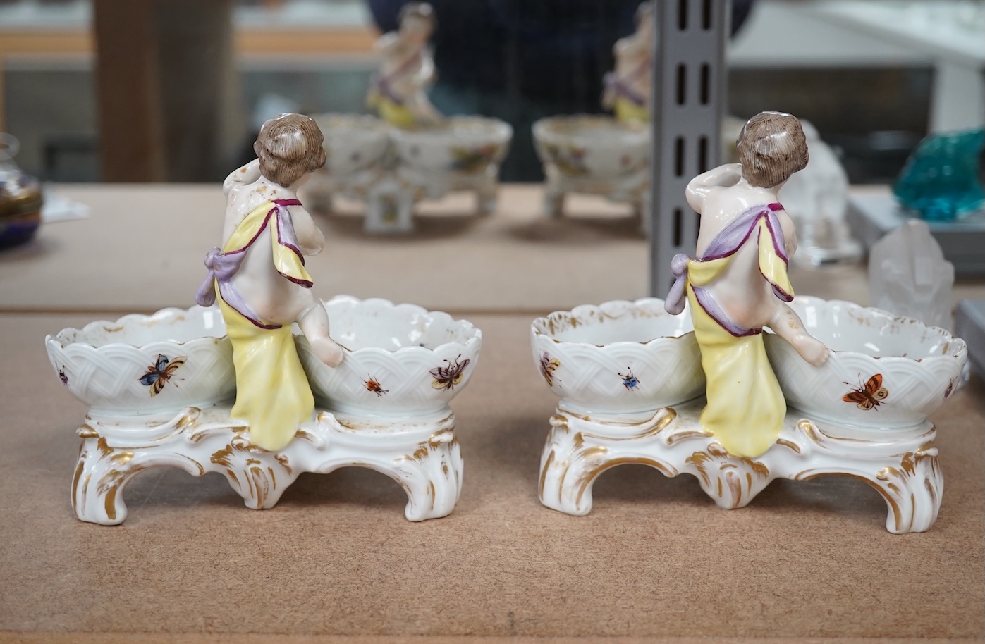 A pair of Berlin figural porcelain salts, hand painted with birds, 13.5cm wide. Condition - fair to good